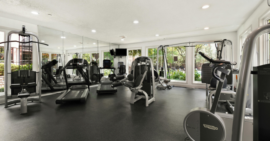 Clean modern gym with cardio and strength equipment showing good daily gym cleaning practices.