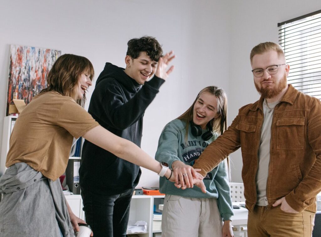 Team celebrating in a clean office, supporting strong office hygiene and a healthier workplace culture.