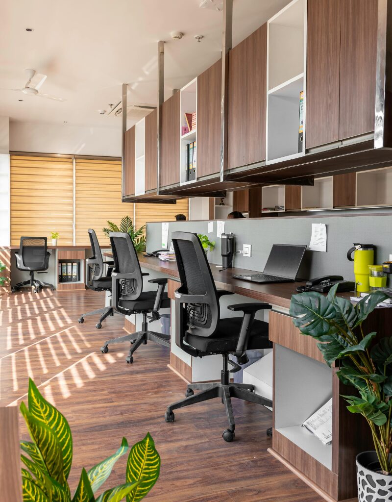 Office hygiene in a clean modern workspace with organised desks, office chairs, and natural light in an open-plan office.